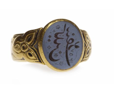 GENTLEMAN'S VICTORIAN TWENTY TWO CARAT GOLD SIGNET RINGset with an oval hardstone carved with middle eastern characters, on e