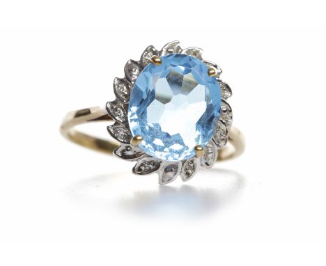 TOPAZ AND DIAMOND CLUSTER RINGthe oval blue topaz of 12x9mm, surrounded by illusion set diamonds totalling approximately 0.05