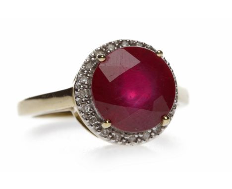 NINE CARAT GOLD RUBY AND DIAMOND RINGset with a single round ruby 10mm diameter within a diamond set border, size N, 3.8g