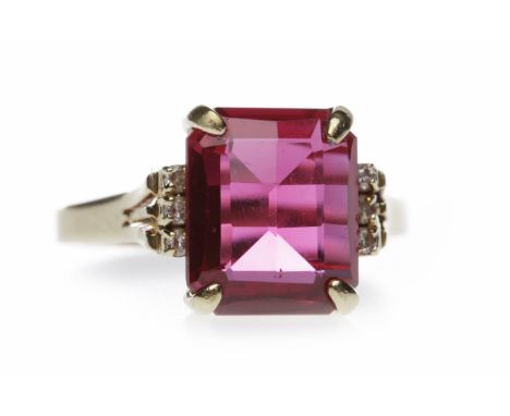 FOURTEEN CARAT GOLD CREATED RUBY AND DIAMOND RINGset with a rectangular mixed cut created ruby 12mm long flanked by three rou