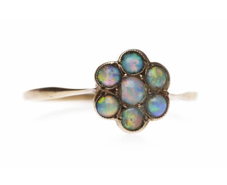 EDWARDIAN NINE CARAT GOLD OPAL RINGthe floral motif bezel with round cabochon cut opals, size L, 1g