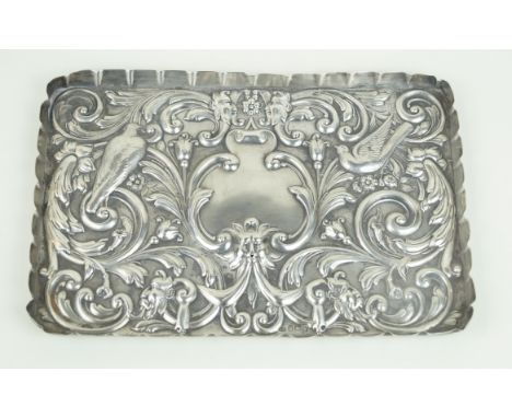 An Edward VII hallmarked silver dressing table trayOf rectangular form, repousse decorated with birds of paradise, mask heads