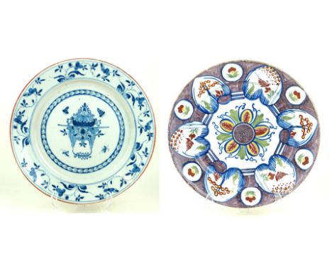 Two 18th Century Delft tin glazed porcelain circular wall chargersThe first painted in multi colours to include red, yellow, 
