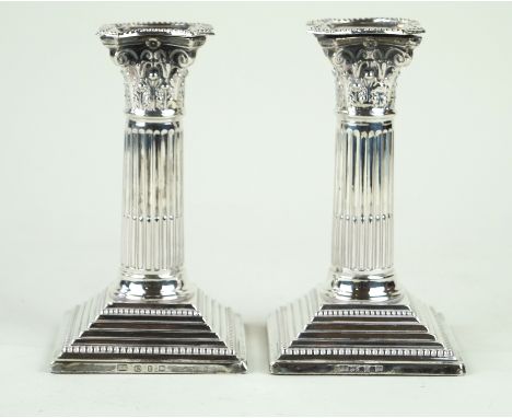 A pair of Victorian hallmarked silver corinthian column candlesticksEach having cast beaded stepped rims, by Barker Brothers,