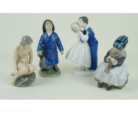 Four Royal Copenhagen and Bing & Grondahl figurinesTo include 'First Kiss', ' Knitting Amager', 'Mermaid' height of largest e