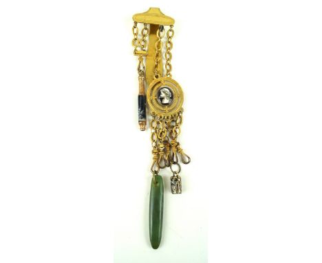 A Victorian gilt metal chatelaineHaving six chains, one containing a jadeite pendant, with central hand-painted ceramic stone