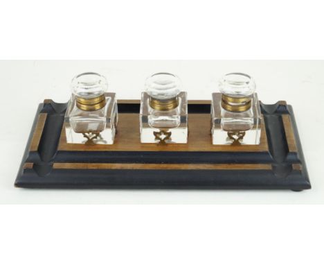 A late Victorian light oak desk standWith three clear glass inkwells, inset within pierced brass holders, length 35cm
