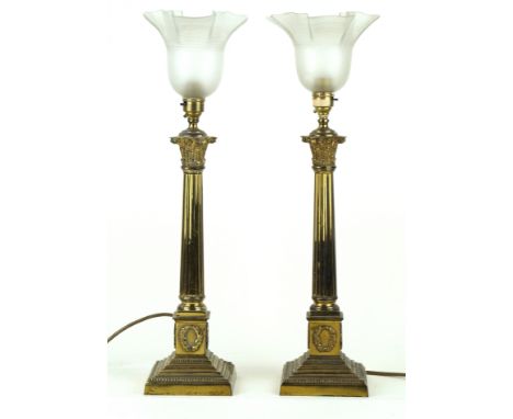 A pair of brass Corinthian column table lampsLate 19th/early 20th Century, each with frosted glass shades with flared rims, h