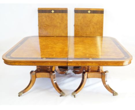 A fine quality Regency style brass inlaid rosewood banded figured walnut veneered dining table, Arthur Brett, Norwich, 20th C