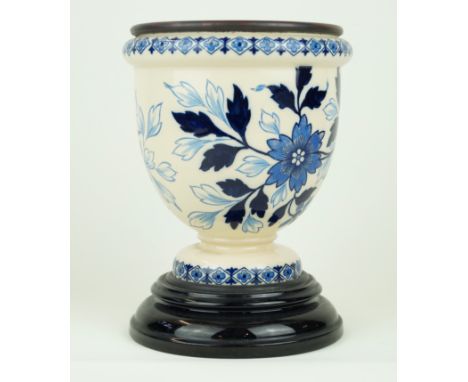 A late 19th Century ceramic oil lamp baseIn the style of Royal Doulton, having blue and white floral decoration, with brass i
