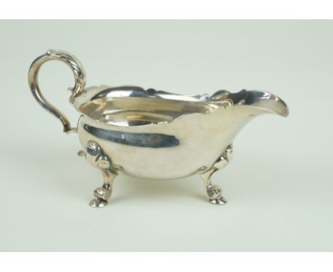 A George II hallmarked silver sauce boatOf plain form, with cast rim, raised on three hoof feet, by Peter Archambo II & Peter