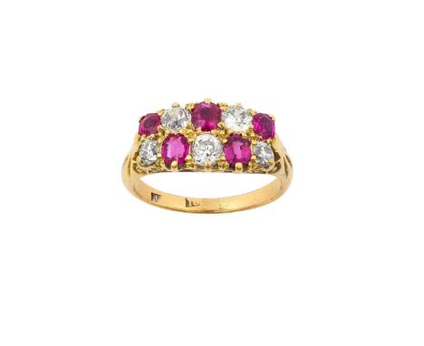 A Ruby and Diamond Ring two rows comprising of oval cut rubies alternating with old cut diamonds, in yellow claw settings, to