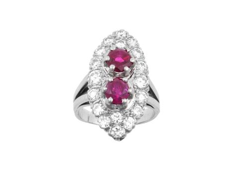 A Ruby and Diamond Cluster Ringthe navette shaped cluster formed of two raised round cut rubies within a border of round bril