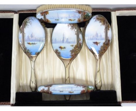 Unusual silver and enamel toilet set comprising a hand mirror, two hair brushes and two clothes brushes in sizes, decorated w