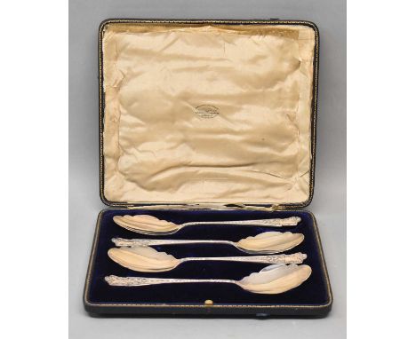 GOLDSMITHS &amp; SILVERSMITHS CO LTD; a cased set of four George V hallmarked silver serving spoons, each with shaped bowl an