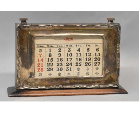 A George V hallmarked silver fronted and ebonised wooden backed perpetual calendar, Birmingham 1925, length 21cm, height 14cm