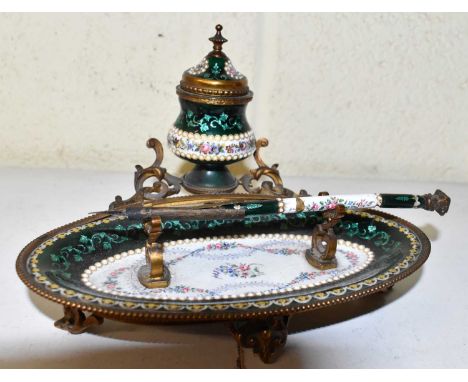A late 19th century gilt metal and enamel oval inkstand, with dip pen, width 18cm.Damage to pen but otherwise appears in good