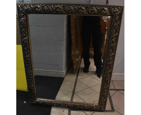 An ornate silver /gilt framed rectangular bevelled wall mirror, 118 x 94cm, and a modern pine framed rectangular mirror, 135 