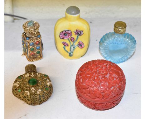 A Chinese yellow ground snuff bottle with green hardstone stopper, three further snuff/scent bottles and a lacquered pill box