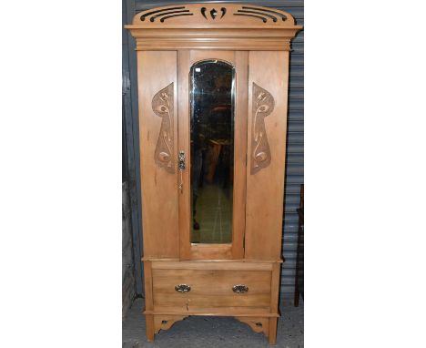 An Arts &amp; Crafts light oak single wardrobe, with mirror door and single drawer, height 204cm, width 83cm, depth 43cm.