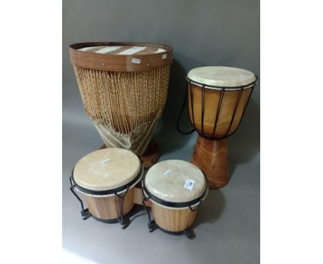 Two African drums and a pair of bongo drums. 