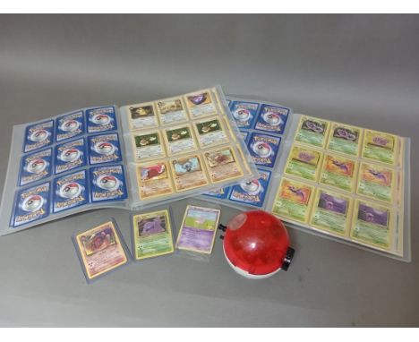 A box containing two binders of vintage 1990s Pokemon cards together with a vintage Pokemon marble blaster with seven marbles