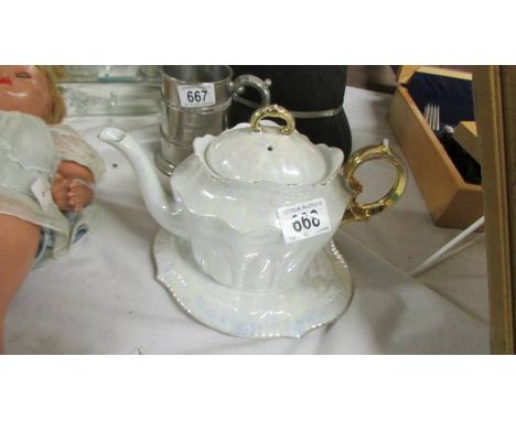 A pretty lustre teapot on stand.