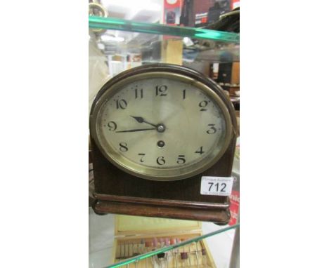 A small mahogany mantel clock.