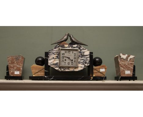 An Art Deco clock garniture, the clock inscribed J. Davoust, Mamers, flanked&nbsp; by a pair of urns, 29cm high and 15cm high
