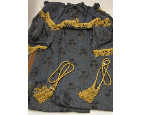 Two extra large cornflower blue brocade curtains with swags and linings, heavily embellished with gold fringing. Matching tie