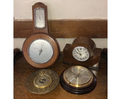 One 20th century mantle clock by Ferranti; together with three wall mounted barometer's, comprising:- one wood and brass moun