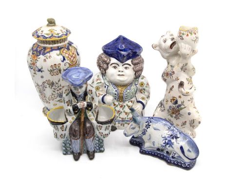 A Quimper pottery female toby jug, a salt modelled as a gentleman in 18th century dress, a candlestick modelled as a cat, a f