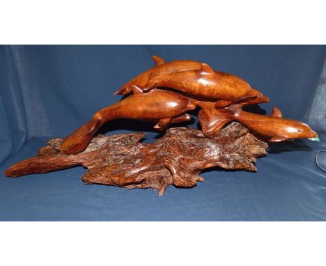 A large rare hand carved model of dolphins , by South African artist wood carver John Blignaut singed by the artist and dated