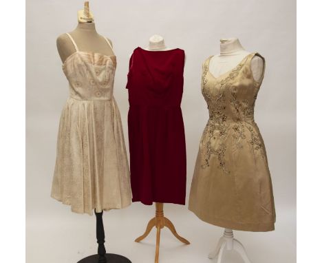 A Red velvet cocktail dress with a low backline with a cuff and bow detail. It has a nylon zip and is 1960s. The bodice is pl