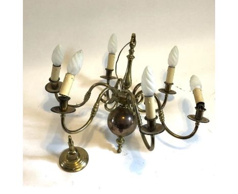 An early 20th century brass six armed chandelier, wired for electricity, with brass ceiling bracket, width 70cm