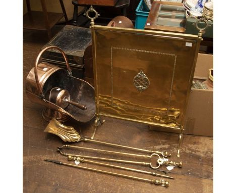 A Victorian copper coal scuttle with scoop, an early 20th century brass firescreen and four early 20th century brass fire iro