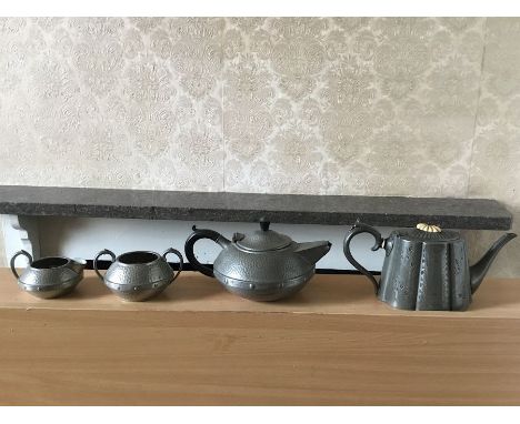 A Sheffield made spot hammered effect teapot in the Knox style, milk and sugar along with another pewter teapot with bone fin