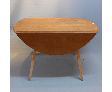 A mid 20th Century Ercol drop leaf table with elm top raised on beechwood base