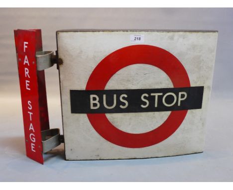 A vintage enameled bus stop sign. 