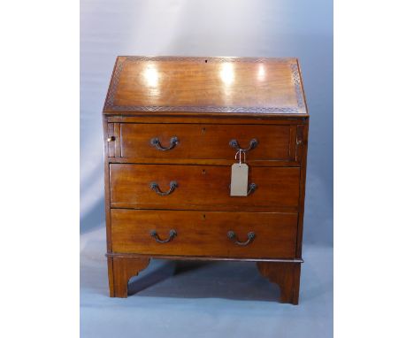 An early 20th Century mahogany bureau with drop down flap above three drawers, raised on carved bracket feet. 
