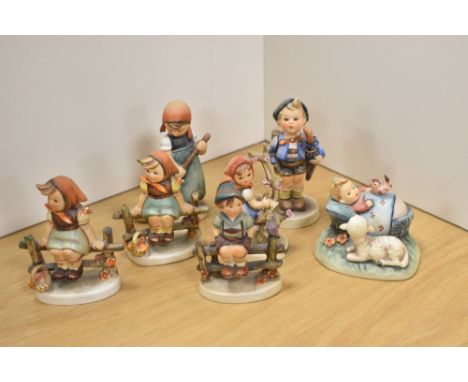 A group of seven Goebel porcelain 'Hummel' figures and figurines, to include 'The Guardian', 'Apple Tree Girl', 'Just Resting