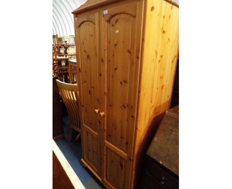 A pine double door wardrobe with inner shelf 