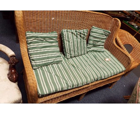 A wicker sofa and cushion seat