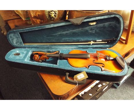 A full size violin in case with new bow and shoulder rest