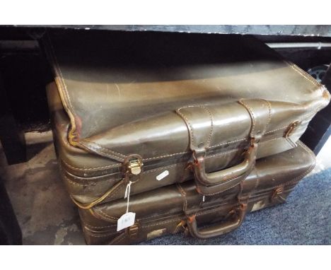 A pair of vintage leather suitcases