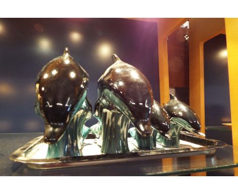 Four Poole dolphin figures