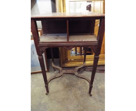 A mahogany library table having two short and long drawers, the reverse with shelf space, resting on fluted tapering supports