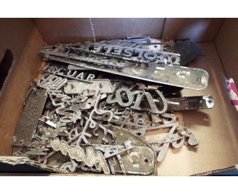 A mixed selection of vintage car badges