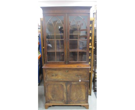 A 19th Century mahogany secretaire bookcase, moulded cornice, over gothic glazed doors, the interior fitted with adjustable s