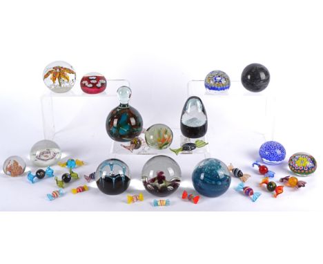 Fourteen glass paperweights, including examples by Selkirk, Murano, Caithness and more, in assorted sizes and designs, togeth